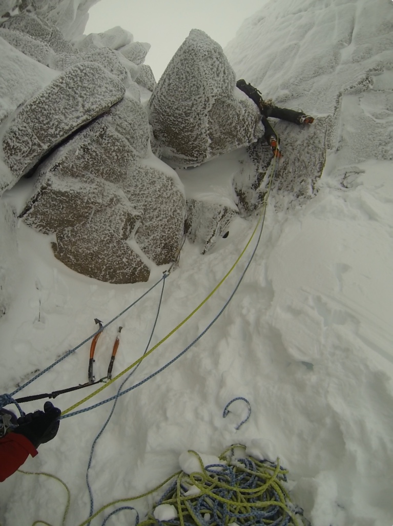 Ben leading up over the tricky chokestone in Fiacaill Couloir.